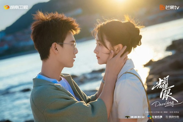 Romantic coastal motorcycle riding scene between the main leads in Dazzling